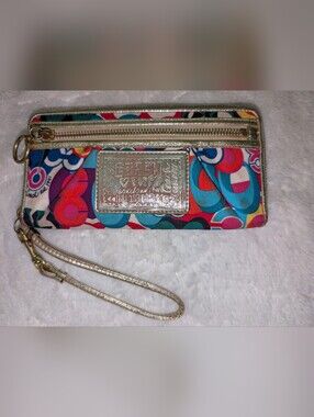 Coach Poppy graffiti print zip-around wristlet with a gold leather wrist strap